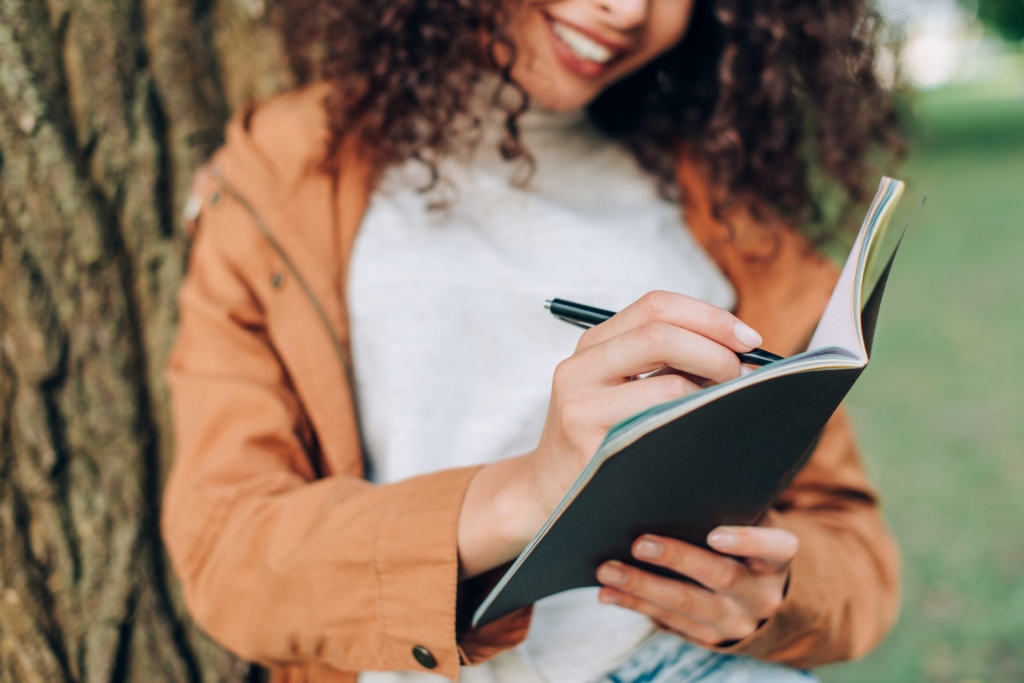 woman writing in notebook