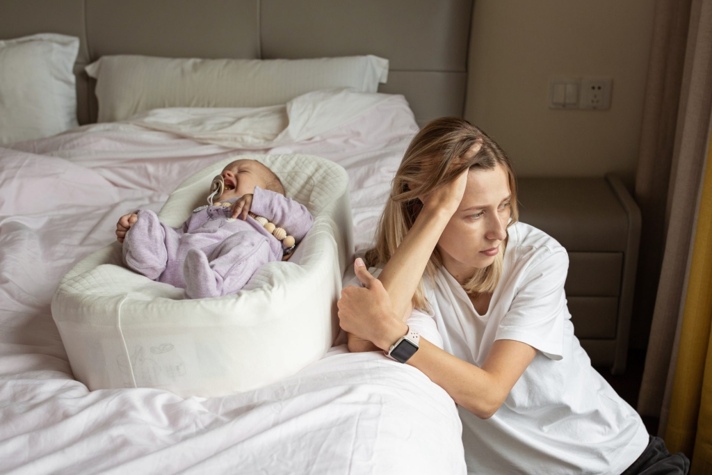 tired mother suffering from experiencing postpartum depression